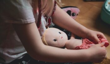 Child playing with doll|mattel gender fluid|
