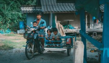 Thai man and children on motorbike